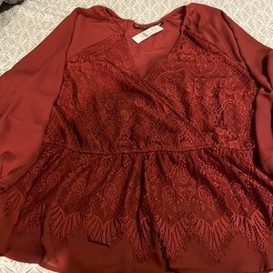 Wine colored dressy wrap top; Also has snip in the front